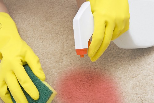 Technician preparing carpet cleaning equipment with safety focus